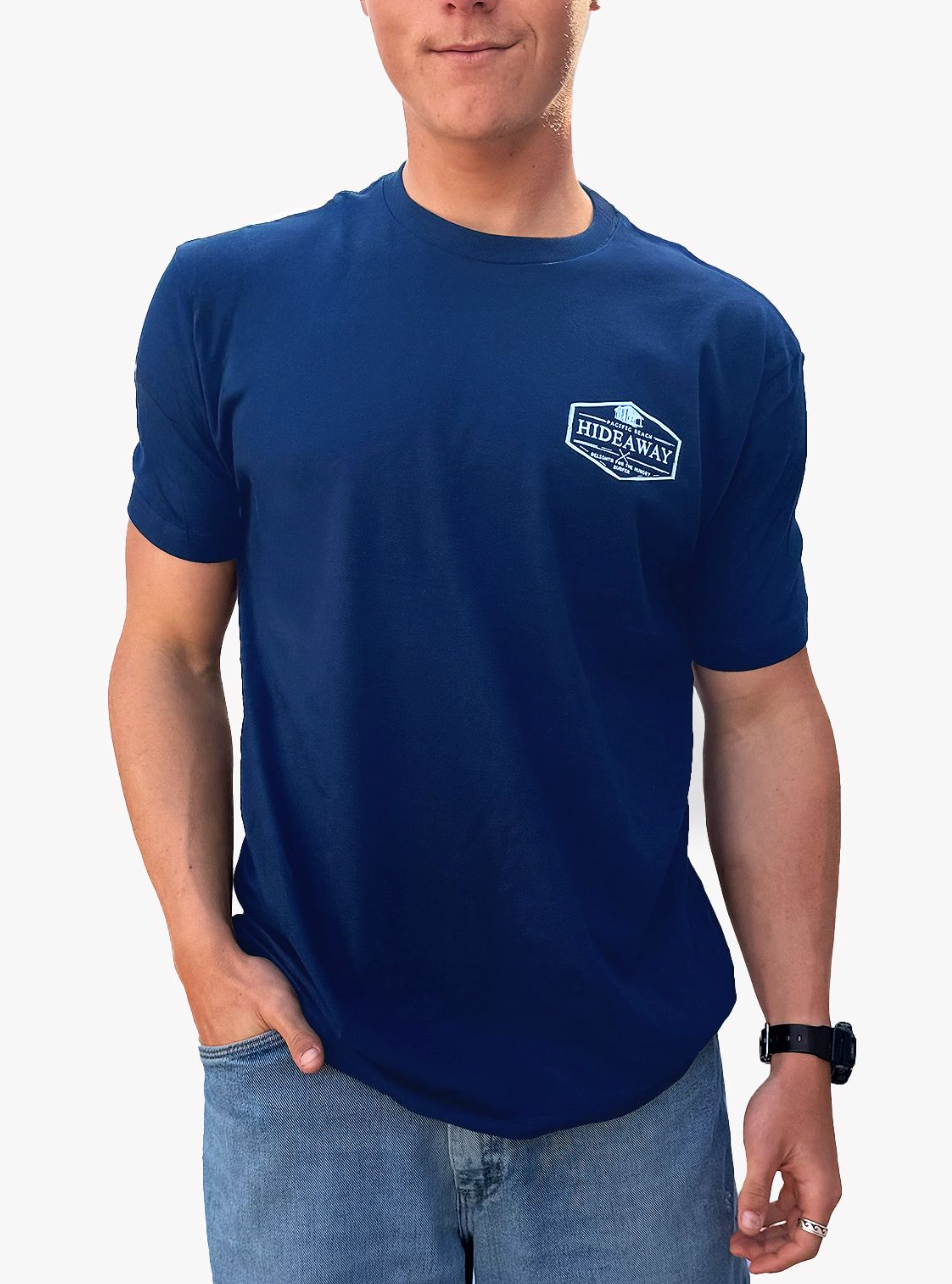 Person wearing a navy blue t-shirt with a logo on a white background