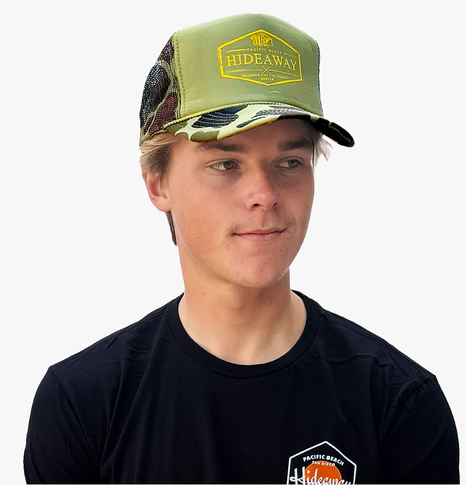 Person wearing a green cap with 'Hideaway' logo on a white background
