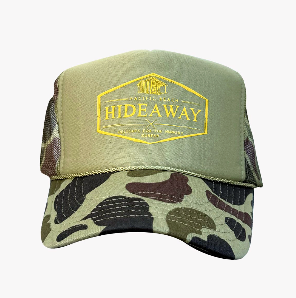 Green and camouflage cap with 'Hideaway' logo on a white background
